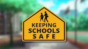 School sign reading keeping schools safe