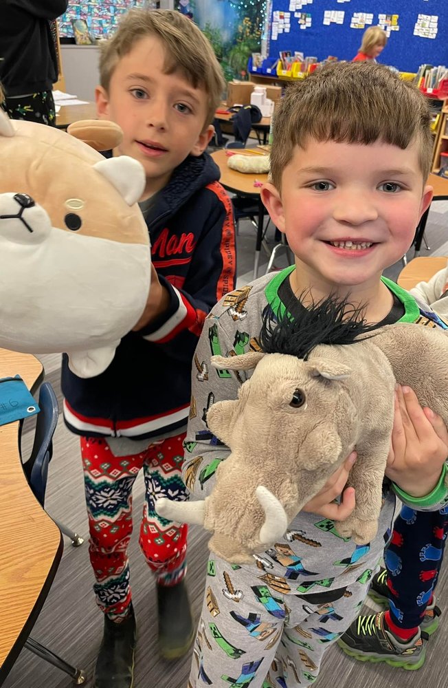 Two happy students with their stuffed animals
