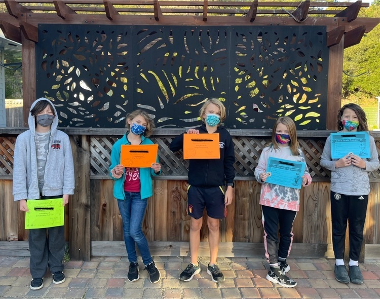 five students with certificates