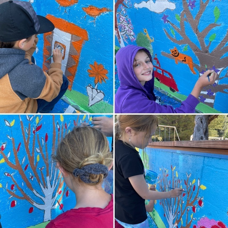 students painting a mural 