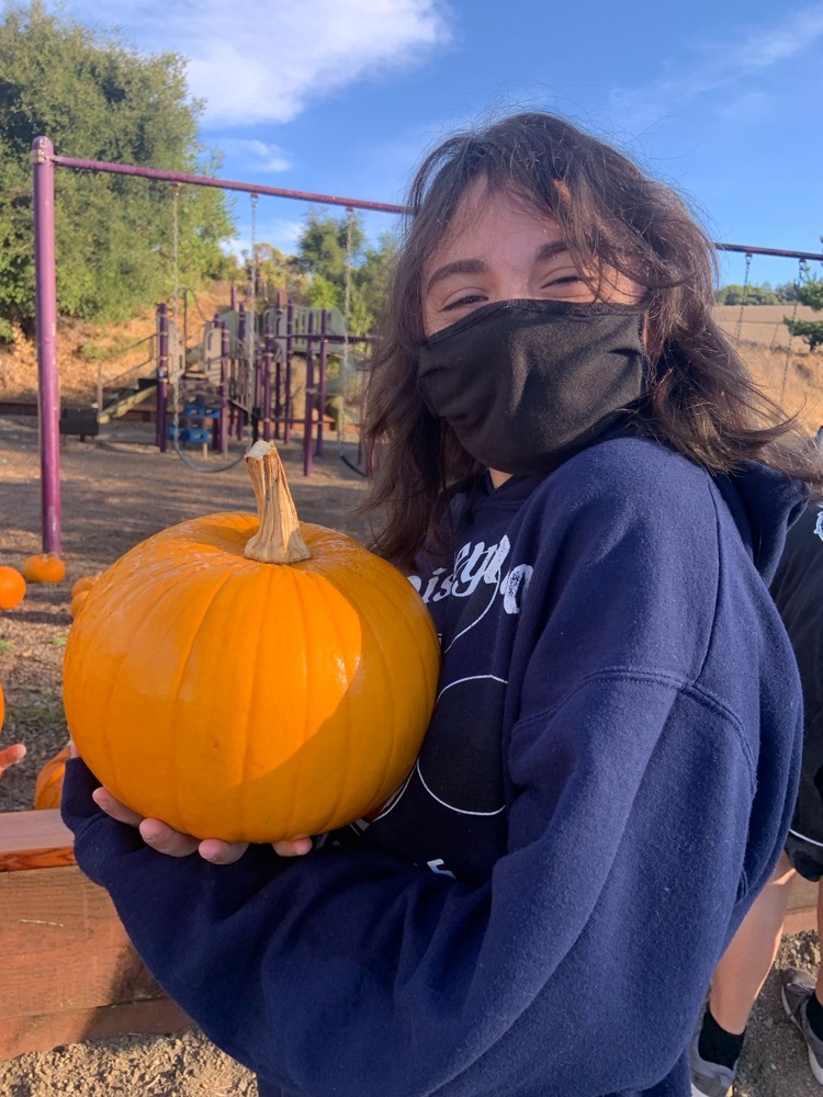 Happy student with her pumpkin 