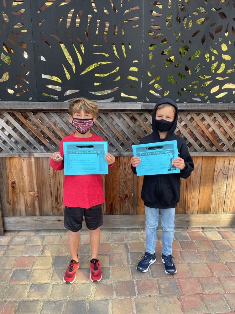 two students with certificates 